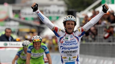 Michele Scarponi of Italy celebrates his victory as he crosses the finish line ahead during the 195km 19th stage of the Giro d'Italia cycling race from Brescia to Aprica May 28, 2010. REUTERS/Alessandro Garofalo/File Photo