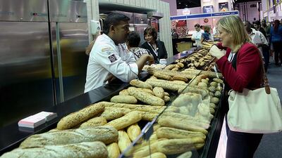 A visitor picks her choice from various breads on display for sale at the Gulfood exhibition in Dubai. Satish Kumar / The National