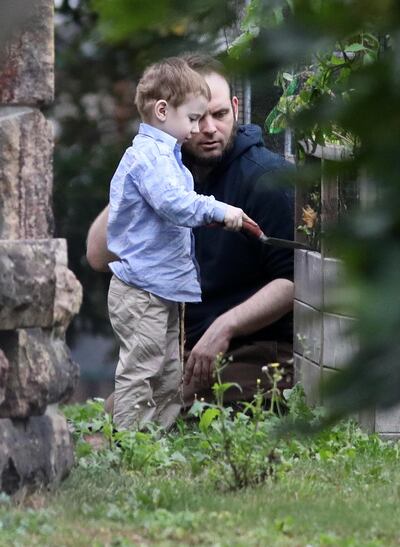 Freed Canadian hostage Joshua Boyle watches as one of his children plays outside the Boyle's family home in Smiths Falls, Ontario, Canada, on October 14, 2017. Mike Carroccetto / AFP