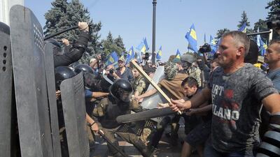 Ukrainian protesters clash with police after a vote to give greater powers to the east, outside the Parliament, in Kiev, on Monday. Efrem Lukatsky / AP