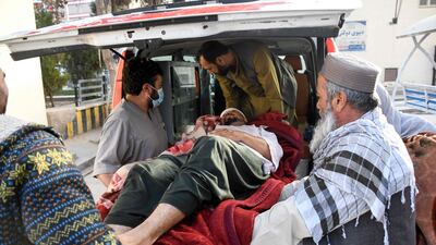 Aan injured man is helped into an ambulance. AFP