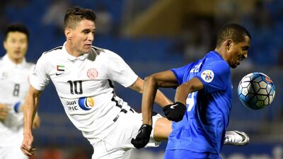 Al Jazira's Thiago Neves, left, vies for the ball against Al-Hilal's Abdullah Al-Zoari during their AFC Champions League Group C football match at the Faisal bin Fahd Stadium in Riyadh on April 6, 2016. / AFP / FAYEZ NURELDINE