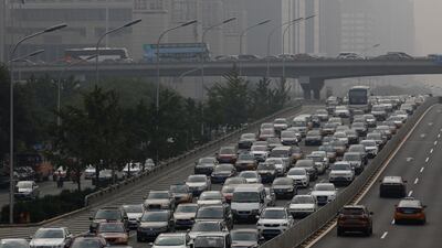 Cars and coaches during a traffic jam as haze covers the highway in Beijing, China. The capital is one of six cities where buying an electric vehicle is considerably easier than obtaining a petrol-powered car. Luke MacGregor/Bloomberg