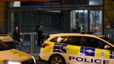Police officers stand near a cordon at Manchester Victoria Station following a terror attack. (Photo by Paul ELLIS / AFP)