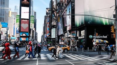 Times Square in New York City. Residents earning an annual income of $100,000 lose more than half of their salary to taxes and inflation. Getty Images