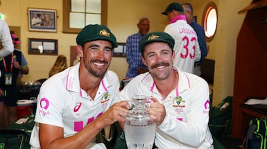 Mitchell Starc, left, and Travis Head pose with the Ashes. The Australians were the dominant figures with bat and ball throughout the five-match series. Getty Images