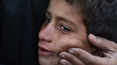 A Palestinian child cries from the cold and harsh living conditions after his family's tent was damaged in Khan Younis in the southern Gaza Strip. EPA