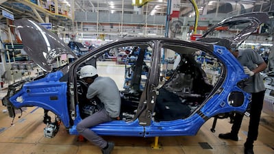 Workers assembling a Tata Tiago car inside the plant in Sanand, on the outskirts of Ahmedabad city in Gujarat. Reuters