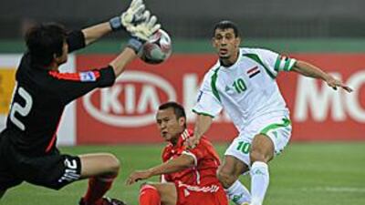 The Chinese goalkeeper Song Zhenyu blocks a shot from the Iraqi Younus Khalaf, right, before China were defeated 2-1 during their crucial World Cup qualifying match at the Olympic Centre Stadium in Tianjin on June 14, 2008.
