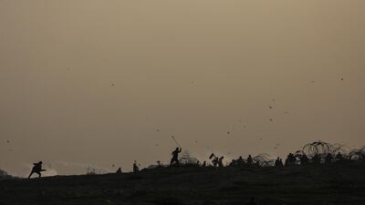 Palestinian protesters also threw stones at Israeli troops during the clashes that erupted after Friday protests near the border between Israel and Gaza Strip. EPA