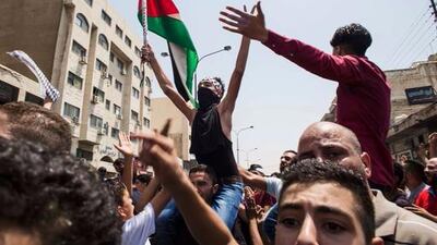 Mourners waving the Palestinian flag march at the funeral of Mohammed Al Jawawdeh, who was killed by an Israeli security guard, in Amman on July 25, 2017. Lindsey Leger / AP
