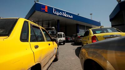 Syrians queue to fill their car with gasoline at a station in the capital Damascus. AFP