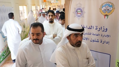 People wait in line to vote during parliamentary elections at a polling station in Kuwait City. Reuters