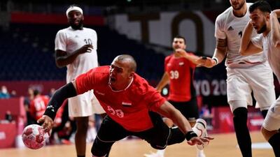 Egypt's pivot Mohamed Mamdouh Shebib jumps to shoot during the men's semi-final handball match againt France at the Tokyo 2020 Olympic Games at the Yoyogi National Stadium in Tokyo. France won 27-23.
