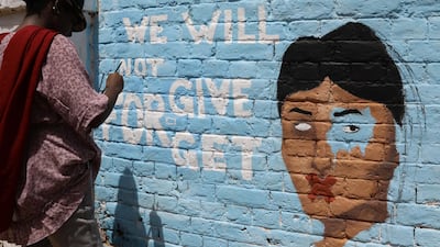 A young Sudanese woman paints graffiti. EPA