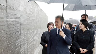 South Korean President Moon Jae-in views a wall inscribed with names of the victims of Argentina's past dictatorship. EPA