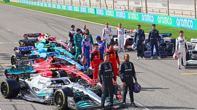 Drivers pose for photos during the first day of F1 pre-season testing at the Bahrain International Circuit. AFP