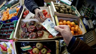 A shopper pays with a euro bank note at a market in France. Food inflation came in above the European Central Bank's target Reuters.