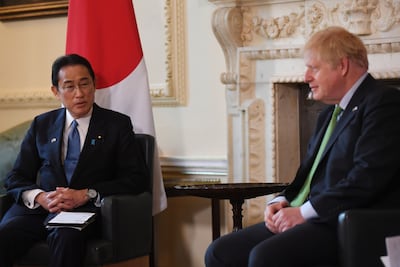 UK Prime Minister Boris Johnson (R) and Japan's Prime Minister Fumio Kishida speak during their bilateral meeting inside Downing Street in London. Bloomberg