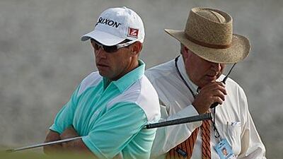 Brian Davis, left, called for an official when he sensed his wedge had moved a loose reed.