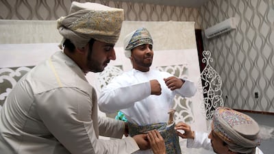 Omani grooms dress up ahead of a mass wedding ceremony of 25 couples in the Al-Mudhaibi province on July 7, 2017. The government is proposing to give Omani men financial assistance if they marry citizens rather foreign women. Mohammed Mahjoub / AFP