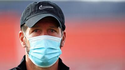 Atletico Madrid head coach Diego Simeone wearing a protective face mask.