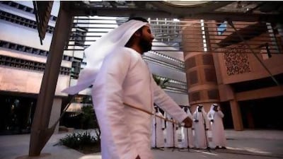 A group of men perform Harbiya, a traditional Emirati dance at the Masdar Institute's eco-friendly campus near Abu Dhabi in. Their display was part of the institute's first annual National Day festivities in 2010. This year's event will take place on Thursday. Lee Hoagland/ The National