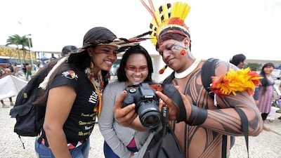 Indigenous people of different ethnic groups look at a photograph on a camera during a protest against the Indian policy of President Dilma Rousseff’s government and the costs of the 2014 World Cup in front of the Planalto Palace in Brasilia. Joedson Alves / Reuters