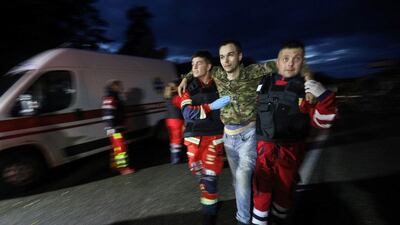 Paramedics help one of the freed Ukrainians. Reuters