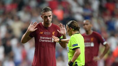 Jordan Henderson of Liverpool argues with referee Stephanie Frappart after a penalty was awarded to Chelsea. Getty Images