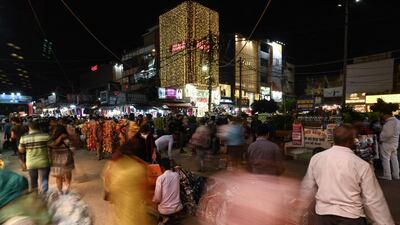 Shoppers at a market ahead of the beginning of Diwali on Tuesday. The global semiconductor shortage has affected manufacturers in India, leading to fewer sales on electronics and cars during the country's festive season. AFP