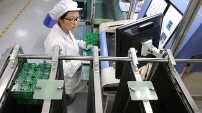 An employee on the production line of a smart electricity meter manufacturing plant in Nantong in eastern China's Jiangsu province. New manufacturing data from China shows a decline in both domestic and overseas orders as a new round of tariffs kicks in. (Chinatopix via AP)