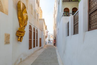 A whitewashed alley on the Pearling Path in Bahrain. Getty Images