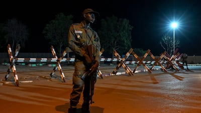 A national police officer outside the French and Niger airbase in Niamey, the capital of Niger. AFP