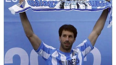 Ruud van Nistelrooy holds a Malaga team scarf.