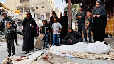 Palestinians mourn over the bodies of relatives after the Israeli strikes on Beit Lahia in northern Gaza. AFP