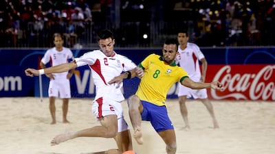 Iran's Amir Akbaro, left, and Brazil's Bruno Xavier vie for the ball during a beach soccer World Cup match between Brazil and Iran at Papeete. Brazil won 4-1. Gregory Boissy / AFP