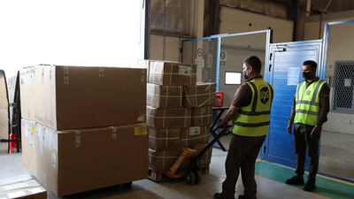 Staff unloading boxes at the UPS warehouse in Jafza in Dubai.