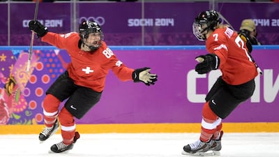 Phoebe Stanz, left, of Switzerland celebrates with teammate Lara Stadler after scoring a third-period goal against Sweden during the Ice Hockey Women's Bronze Medal Game on February 20, 2014. Harry How / Getty Images