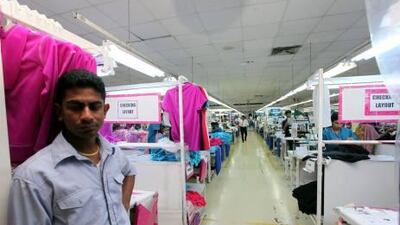 A supervisor stands inside the premises of a Jordan-based garment manufacturer for a top US retailer in Irbid, Jordan, where a Sri Lankan manager has been accused of rape by a young Bangladeshi worker. Mohammad Hannon / AP Photo