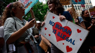 People hold anti-racist placards as they take part in a demonstration outside of the headquarters of the Reform UK party, on August 10, London. AFP