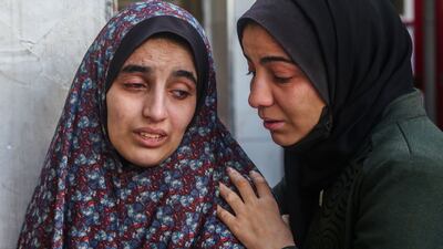 The loved ones of victims of an Israeli strike in Rafah mourn and comfort each other. Getty Images