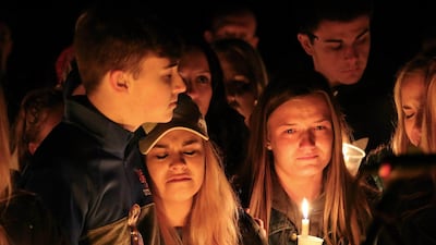 People attend a vigil for the victims of a fatal shooting at Marshall County High School, Kentucky, after a 15-year-old accused of the fatal shooting was arrested on preliminary charges of murder and assault / AP