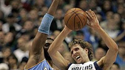 Dallas's Dirk Nowitzki drives for the Nuggets' net.