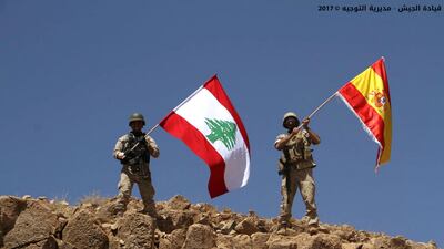 Lebanese soldiers wave Lebanese and Spanish flags to show their solidarity with Spain after the attacks in Barcelona and Cambrils, on Mkheirameh Mountain, that was captured from ISIL, in north-eastern Lebanon. Lebanese Army Website via AP