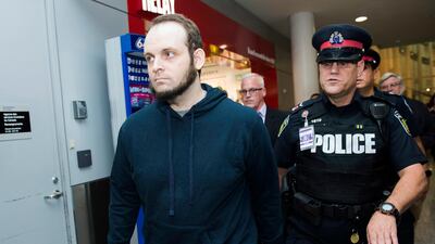 Joshua Boyle gets a police escort after speaking to the media after arriving at the airport in Toronto in October 2017. Mr Boyle has been arrested on 15 charges including sexual assault, illegal confinement and issuing death threats. Nathan Denette / The Canadian Press via AP