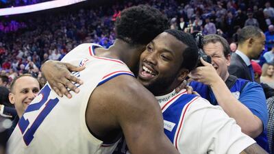 Philadelphia 76ers centre Joel Embiid (21) hugs recording artist Meek Mill Bill Streicher-USA TODAY Sports