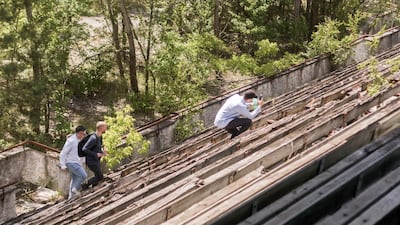 Tourists search for photo opportunities amongst the seating in the decaying sports stadium. Bloomberg