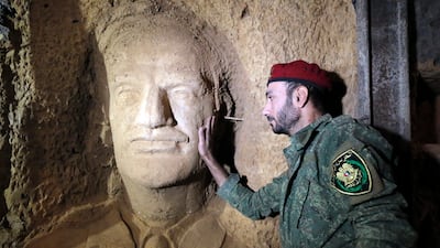 Muhannad Moualla, an artist and fighter in the Syrian army, stands inside a tunnel. EPA