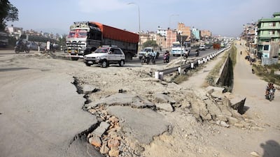 Vehicles pass a section of an earthquake-damaged road in Kathmandu. Prashanth Vishwanathan / Bloomberg